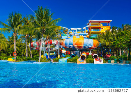 water park in pool at resort on summer vacation. Colorful aquapark with slides water park in pool at resort on summer vacation. Colorful aquapark with slides 138662727