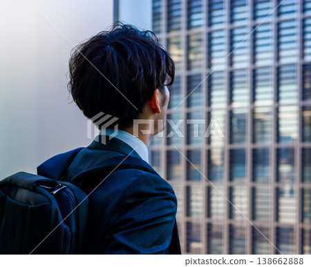 一位商人抬頭望向窗外的建築物。 138662888