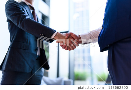 Agreement reached through a handshake between businessmen Agreement reached through a handshake between businessmen 138662890