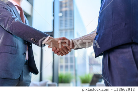 Businessmen shake hands to sign a partnership Businessmen shake hands to sign a partnership 138662918