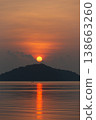 Serene sunrise over calm sea with silhouetted island creates tranquil atmosphere at Phuket city 138663260