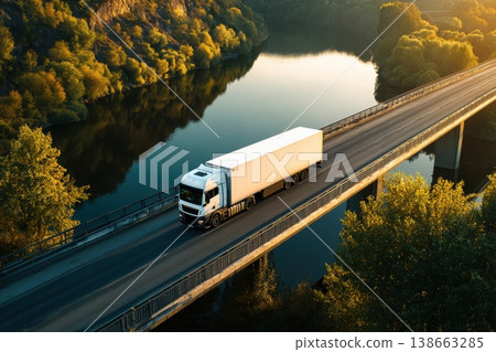 White Truck Driving on Highway Bridge Over Calm River During Sunset White Truck Driving on Highway Bridge Over Calm River During Sunset 138663285