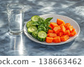 Freshly Cut Melon and Cucumber Platter with Glass of Water on Table 138663462