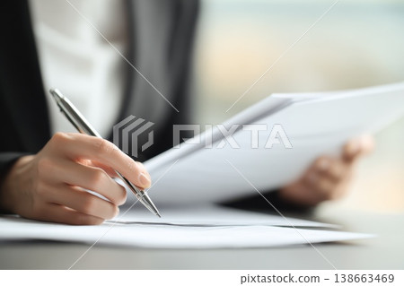 Close-Up of Recruiter's Hands Holding Printed Resume and Preparing for Job Interview Review 138663469