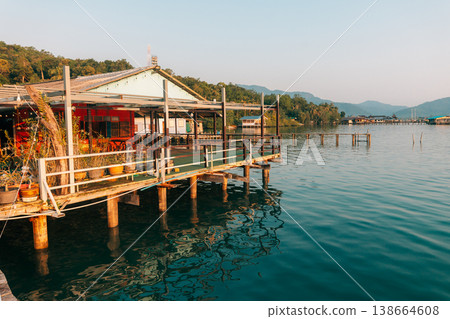 Waterfront wooden stilt houses and homestay over clear tropical sea. Waterfront wooden stilt houses and homestay over clear tropical sea. 138664608