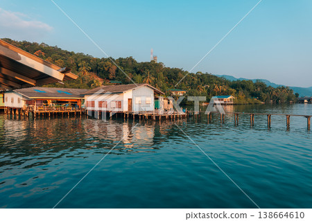 Waterfront wooden stilt houses and homestay over clear tropical sea. Waterfront wooden stilt houses and homestay over clear tropical sea. 138664610