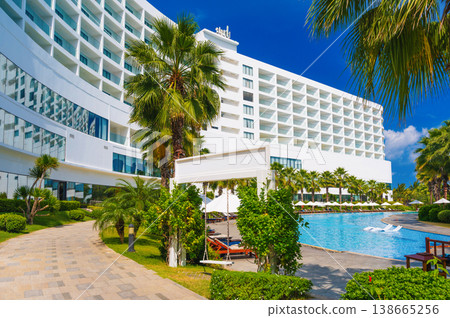 luxury hotel with a swimming pool and palm trees in summer resort in Asia luxury hotel with a swimming pool and palm trees in summer resort in Asia 138665256