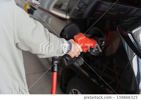 A scene of someone refueling at a gas station. 138666325