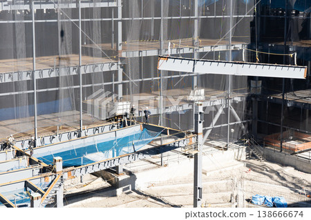 A scene from a steel frame construction site: lifting steel beams with a crane (2) 138666674