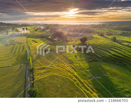 Beautiful morning view in Indonesia, panoramic landscape of rice fields with mountain ranges and clear sky Beautiful morning view in Indonesia, panoramic landscape of rice fields with mountain ranges and clear sky 138666703