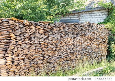 Stacked firewood neatly arranged against a rustic brick wall Stacked firewood neatly arranged against a rustic brick wall 138666858