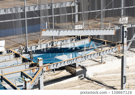 A worker guiding a suspended load with a rope at a steel frame construction site, and a crane lifting operation (2) A worker guiding a suspended load with a rope at a steel frame construction site, and a crane lifting operation (2) 138667128