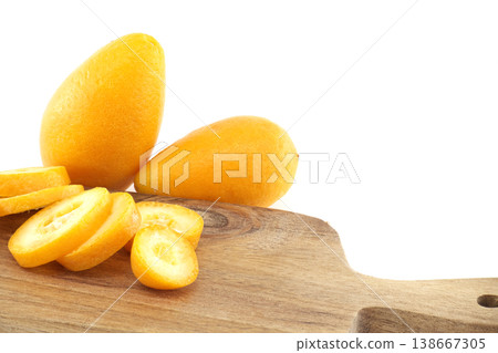 Fresh Kumquats On Wooden Cutting Board With Sliced Citrus Fruit On White Background Fresh Kumquats On Wooden Cutting Board With Sliced Citrus Fruit On White Background 138667305