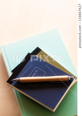 Notebook and ballpoint pen on top of the book Notebook and ballpoint pen on top of the book 138667627