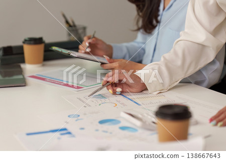 Collaborative financial analysis with charts and reports in an office Collaborative financial analysis with charts and reports in an office 138667643