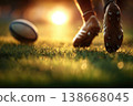 Rugby player kicking ball during sunset on grass field 138668045