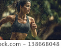 Young slim sporty woman running alone in a city park. Girl in sportswear jogging outdoor 138668048