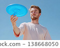 Man catching ultimate frisbee disk during outdoor sport 138668050