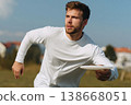 Man holding frisbee preparing to throw in urban park sunset 138668051