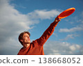 Man catching ultimate frisbee disk during outdoor sport 138668052