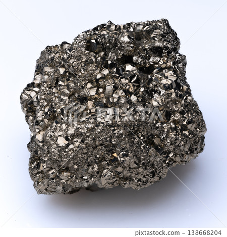 Close up of natural shiny pyrite mineral specimen with metallic golden luster on white background. Close up of natural shiny pyrite mineral specimen with metallic golden luster on white background. 138668204