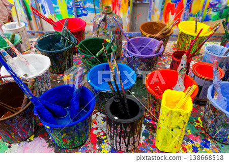 Colorful Paint Cans and Brushes on Splattered Studio Table Puppet Theater 138668518