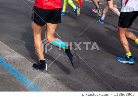 Male runner legs, on calf muscle kinesiotaping Male runner legs, on calf muscle kinesiotaping 138668905