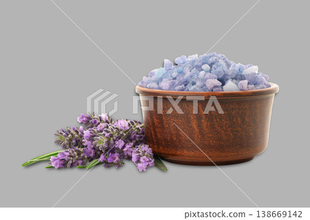 Salt in brown bowl with lavender flowers beside it Salt in brown bowl with lavender flowers beside it 138669142