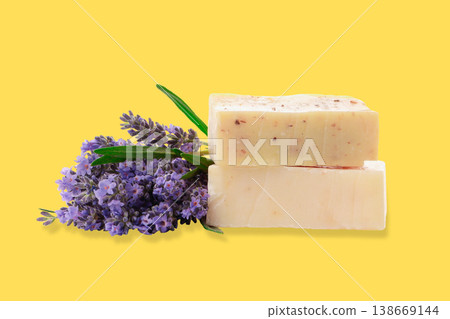 Two soap bars next to a bunch of lavender flowers Two soap bars next to a bunch of lavender flowers 138669144