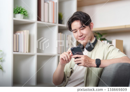 Man enjoying digital content on smartphone with headphones 138669809