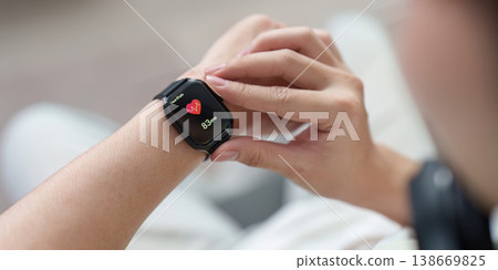 Smartwatch displaying heart rate on wrist 138669825