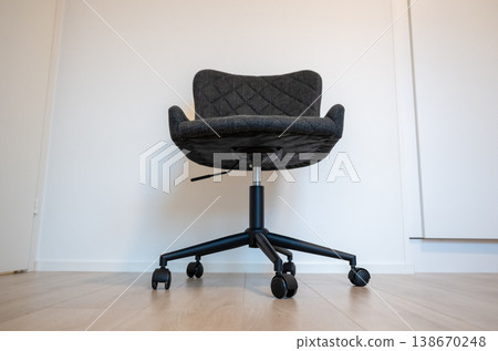 Modern ergonomic office chair with wheels in minimalist interior workspace clean Scandinavian design 138670248