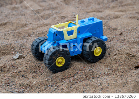 Toy construction truck in sandbox playground close up childhood play concept 138670260