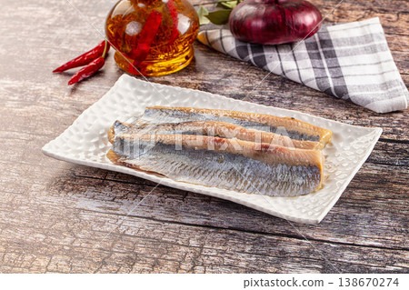 Marinated pickled salted herring fillet Marinated pickled salted herring fillet 138670274
