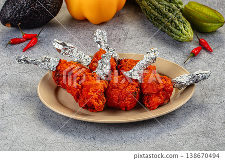 Spicy Indian Chicken Lollipops appetizer in a bowl with fresh vegetables Spicy Indian Chicken Lollipops appetizer in a bowl with fresh vegetables 138670494