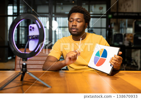 African American influencer showing chart during live presentation 138670933