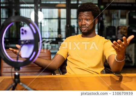 African American blogger gesturing with hands during live stream 138670939