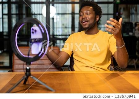 Male influencer explaining topic during live video recording 138670941