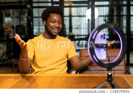 African American host gesturing and talking to audience during stream African American host gesturing and talking to audience during stream 138670942