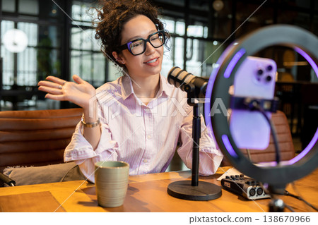 Female host gesturing and talking during live stream Female host gesturing and talking during live stream 138670966
