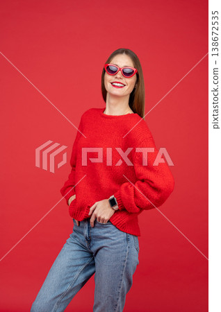 Cheerful woman in sunglasses standing confidently 138672535