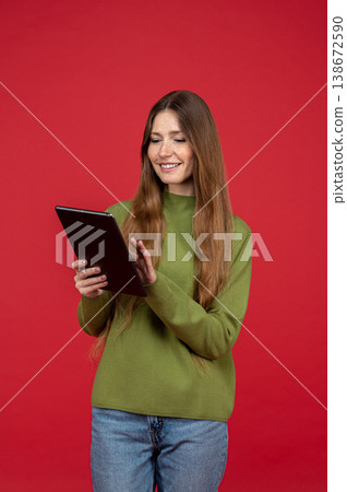 Smiling woman using tablet device and interacting with touch screen Smiling woman using tablet device and interacting with touch screen 138672590