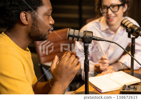 Close up of man talking into microphone during filming Close up of man talking into microphone during filming 138672615