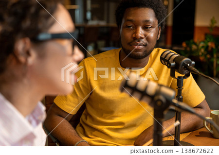 Woman listening to partner during audio content creation Woman listening to partner during audio content creation 138672622