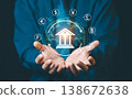 Businessman hands holding glowing bank icon with global currency symbols and world map, international banking and global financial exchange concept. 138672638