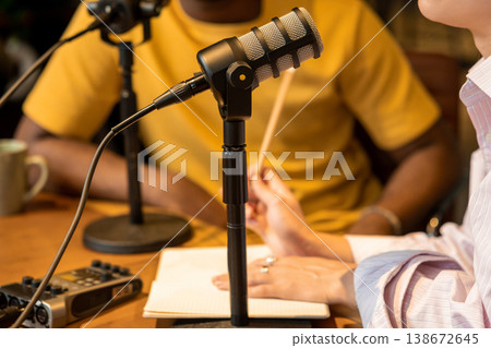 Woman holding pencil and talking during podcast recording Woman holding pencil and talking during podcast recording 138672645
