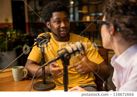 Man pointing and talking to colleague in studio Man pointing and talking to colleague in studio 138672668