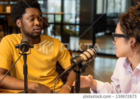 African American man talking into microphone during podcast interview African American man talking into microphone during podcast interview 138672673