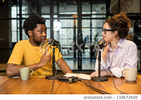 African man explaining idea to female colleague in studio 138672680