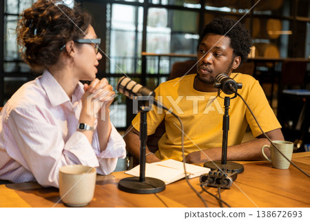 Woman talking to man while recording audio content Woman talking to man while recording audio content 138672693